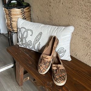 Toms brand new they are brown and tans with a cute tassel in the front of them.